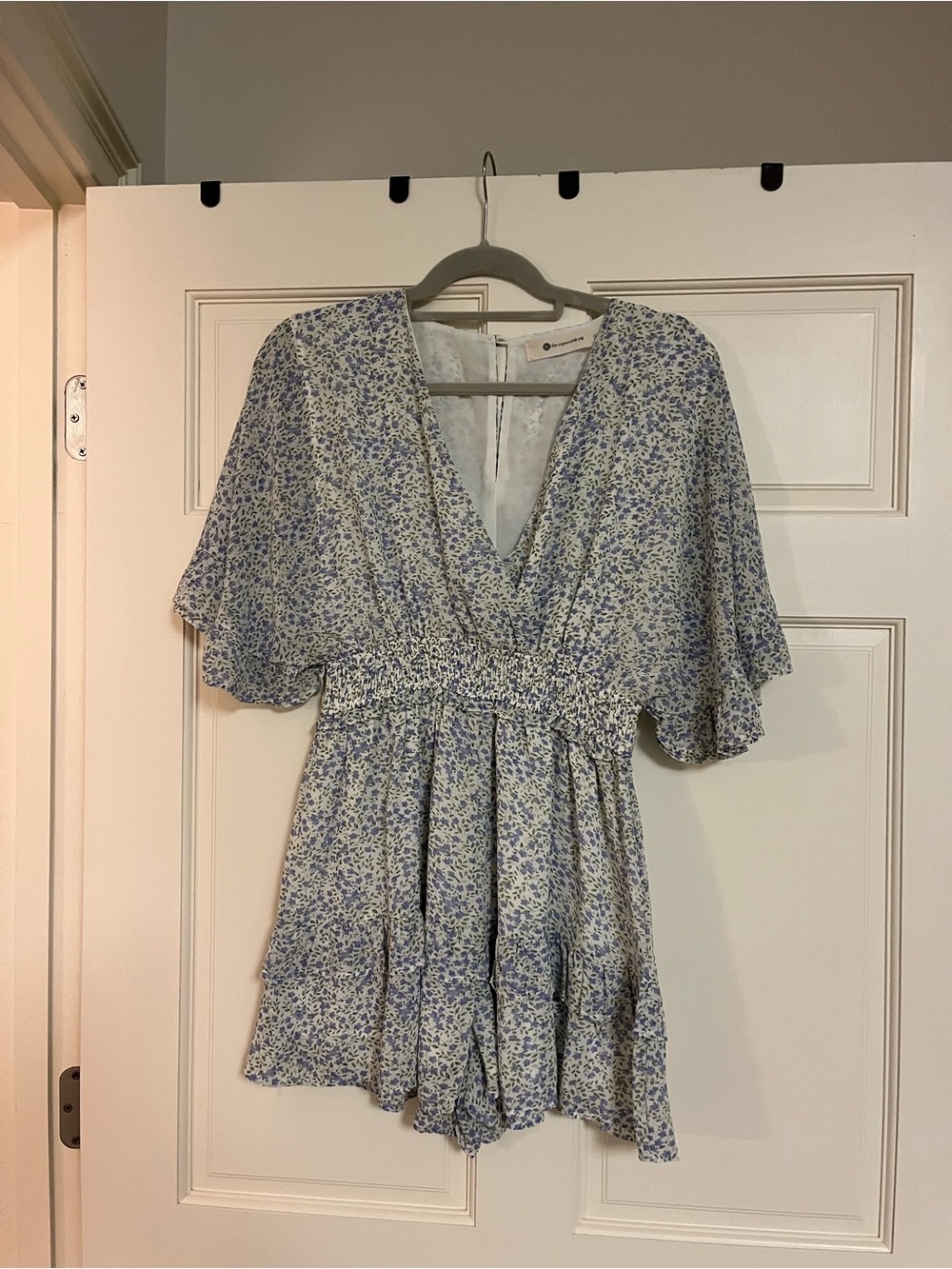 The Impeccable Pig Flutter Sleeve V-Neck Floral Romper in Light Blue - Size S
